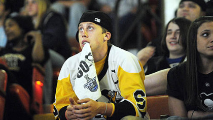 Penguins' fan Zack Ziemianski, of Lower Burrell, watches at Mellon Arena last night as his team's early 2-0 lead over the Red Wings slips away.  The Penguins won a marathon game but still trail in the series, three games to two.