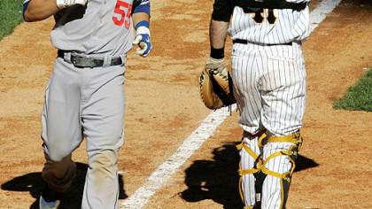 Dodgers' Russell Martin, scores past  Ryan Doumit on a RBI single by James Loney in the 12th inning yesterday at PNC Park.