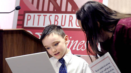 Cameron Greenaway, 7, of Baldwin shows his "Pittsburgh Valentine" to Toni Staab of McKees Rocks during a luncheon with Mayor Luke Ravenstahl at the City-County Building.