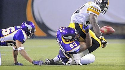 The Vikings' Kevin Williams knocks the ball loose from the grasp of Steelers Rashard Mendenhall in the first half of the preseason game in Minneapolis.