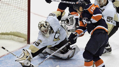 Penguins goalie Ty Conklin (35) blocks a shot on goal from New York Islanders' Richard Park (10) as teammate Sergei Gonchar (55), of Russia, helps defend during the third period of last night's  hockey game in Uniondale, N.Y.