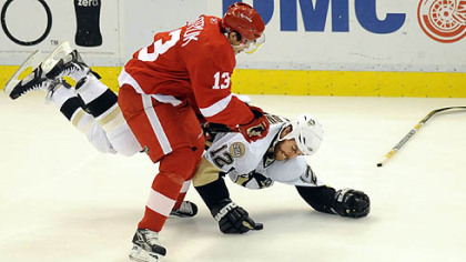Ryan Malone is upended by the Red Wings' Pavel Datsyuk.
