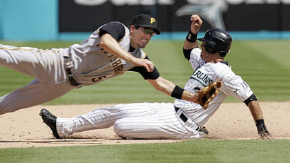 Marlins' Jorge Cantu slides safely past Pirates second baseman Chris Gomez with a stolen base yesterday in the eighth inning. The Pirates won, 9-2.