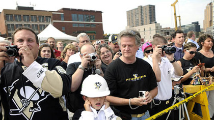 Justin Hackman, 8, of Baldwin, anticipates a loud noise yesterday during groundbreaking for the new Penguins arena.