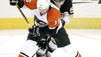 Penguins' Kris Letang, rear, gets his stick behind the skate of the Flyers' Joffrey Lupul in the game Sunday. The Penguins wrap up the regular season with a home-and-home series against the Flyers.