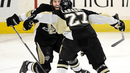 Penguins Maxime Talbot celebrates his third-period goal against the Flyers with teammate Georges Laraque Sunday.