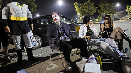 Keith Pfender, of Washington, David Kirik, of Brentwood, Elliott Stone, 16, of Mt. Lebanon, and Megan Kirik, 16, of Brentwood, tailgate in front of Loews Theatres at the Waterfront before the opening of the new Batman movie, "The Dark Knight," last night.