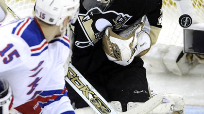 Penguins Marc-Andre Fleury makes a save in front of Rangers Blair Betts in the first period Friday night at Mellon Arena.
