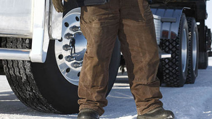 Hugh Rowland stands next to his truck in "Ice Road Truckers."
