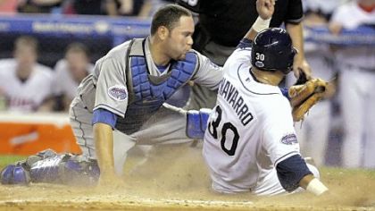Tampa Bay Rays' Dioner Navarro (30) of the American League is out at the plate after a throw from center field by the Pirates' Nate McLouth in the 11th inning. National League catcher Russell Martin of the Los Angeles Dodgers applies the tag that kept the NL alive for four more innings.