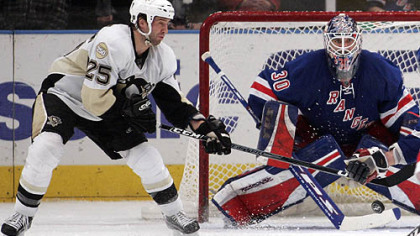 New York Rangers goalie Henrik Lundqvist, of Sweden, defends the net as the Penguins' Maxime Talbot (25) reaches for a rebound during the second period of their NHL hockey game at Madison Square Garden in New York last night.
