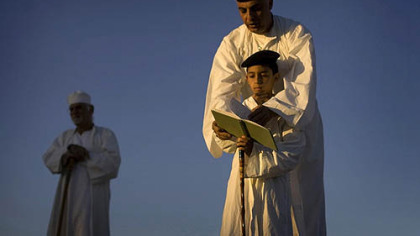 MOUNT GERIZIM, Palestine -- Members of the ancient Samaritan community pray during the pilgrimage for the holiday of the Tabernacles or Sukkot at the religion's holiest site near the West Bank town of Nablus, Monday, Oct. 13. Named for Samaria, a region in the northern West Bank, the Samaritans believe themselves to be the remnants of Israelites exiled by the Assyrians in 722 B.C. They practice a religion closely linked to Judaism and venerate a version of the Old Testament, but are not Jews.