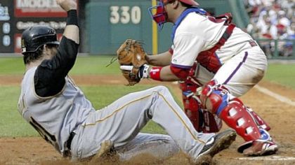 The Pirates' Ryan Doumit scores as the Phillies' Carlos Ruiz waits for the ball in the sixth inning.