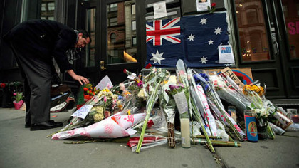 Henry Caban, 35, places flowers in front of a makeshift memorial for actor Heath Ledger outside his apartment building yesterday, in the SoHo neighborhood of New York.  Funeral arrangements for Ledger have been completed and his relatives are expected to arrive in New York today, according to a funeral home spokesman. Ledger, 28, died on Tuesday.