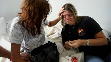 CANTON, Tx. -- Stefanie Voss, left, of Gilchrist, Texas, comforts Sandy King while discussing rumors that mutual loved ones may not have survived Hurricane Ike, at Lakeside Baptist Church.
