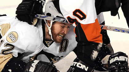 Penguins Ryan Malone is knocked to the ice by the Flyers Vaclav Prospal.