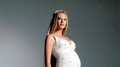Ivory beaded floor-length gown and train by A Pea in the Pod.