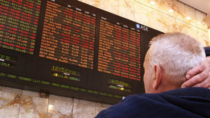 MELBOURNE -- A man studies a fluctuating Australian Securities Exchange board after Australia's central bank slashed interest rates by a full 100 basis points amid fears of a global slowdown sparked by the US-based financial crisis on October 7, 2008.