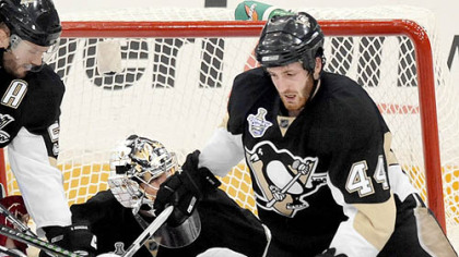 The Penguins' Brooks Orpik (44) sends the Red Wings' Valtteri Filppula to the ice Wednesday at Mellon Arena.