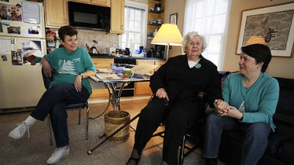 Dr. Ann Baldwin Taylor, center, and her daughter Kate Golightly, right, with caregiver, Joyce Starek, sit in Dr. Taylor's light-filled kitchenette.