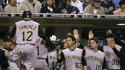 The Pirates' Freddy Sanchez (12) is greeted at the dugout after Doumits' three-run home run against the San Diego Padres in the sixth inning of last night's game Friday in San Diego.