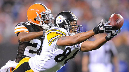 Hines Ward stretches out for a pass from Ben Roethlisberger past the Browns' Terry Cousin.