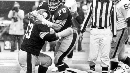 Steelers Dwight White (78) and Ernie Holmes (63) congratulate each other after sacking Oakland Raiders quarterback, Ken Stabler, for a nine-yard loss in this 1976 game.