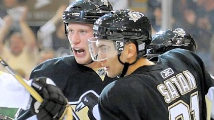 Jordan Staal celebrates Miroslav Satan's goal last night. For 57 minutes, the goal seemed as if it would stand up behind Marc-Andre Fleury before the Devils rallied to disappoint the opening night crowd at Mellon Arena.