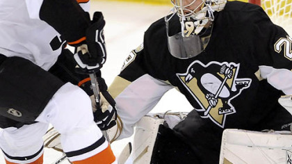 The Penguins' Marc-Andre Fleury makes a save on Flyers R.J. Umberger in the first period tonight in Game 1 of the Eastern Conference final series at Mellon Arena.