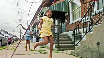 Getting some bone-building exercise on a day in August, Jasmine Fulton, 10, jumps rope with her sister, Felicia , left, 12, and her stepsister Myeishia Knight, 12, not pictured, outside their house in Lawrenceville.