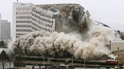 Detonations bring down the building.
