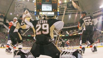 The Penguins' Marc-Andre Fleury makes the save against the New York Islanders Thursday at the Mellon Arena in Pittsburgh, Pennsylvania. The Penguins defeated the Islanders 3-1.