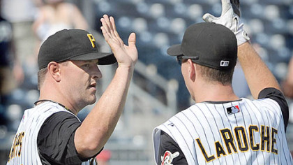 Pirates closer Matt Capps, left, celebrates with Adam LaRoche yesterday after getting the final out in the ninth inning against the Diamondbacks. Capps earned his 14th save and LaRoche went 3 for 4 in the win.