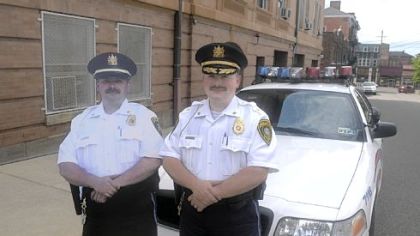 Which one is the real chief? Look carefully at the hats and it's Bellevue police chief Matthew Sentneron the right.