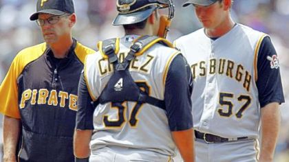 Pirates' pitching coach Jeff Andrews, left, catcher Raul Chavez, center, and starting pitcher Zach Duke talk on the mound after he gave up an RBI double to Colorado Rockies' Ian Stewart in the fifth inning of the Rockies' 11-3 victory.
