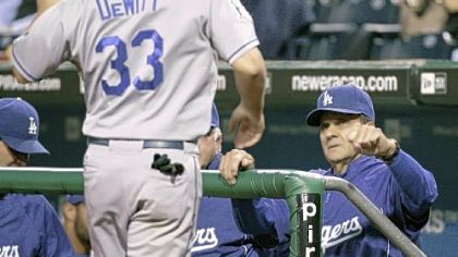 Dodgers manager Joe Torre welcomes Blake DeWitt back to the dugout after  DeWitt scored in the four-run Dodgers second inning.