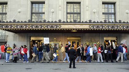 Approximately 50 people march and chant at an AFL-CIO sponsored demonstration while Sen. John McCain speaks at a luncheon inside the Omni William Penn Hotel, Downtown, yesterday.