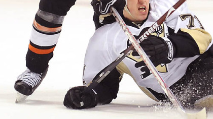 Penguins center Evgeni Malkin is dropped to the ice by the Flyers' Braydon Coburn yesterday in Philadelphia.