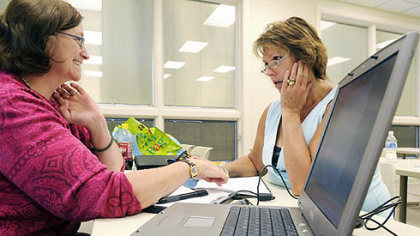 At Community College of Beaver County, assistant math professor Maryanne Frabotta, left, helps student Lori Knaggs through a problem during a break in class. Ms. Frabotta teaches the developmental math course she's devised for students enrolled for the summer session.
