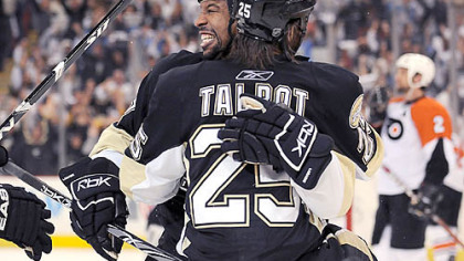 Penguins Georges Laraque congratulates Max Talbot after scoring the winning goal.