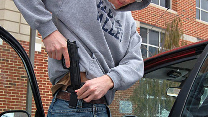 Nathaniel Sheetz, a Penn State masters student from Lancaster, returns to his car after retrieving his handgun from the campus police station. Mr. Sheetz is a member of Students for Concealed Carry on Campus.