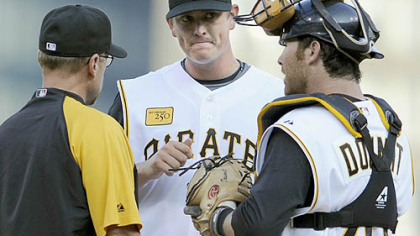 Pirates pitching coach Jeff Andrews and Ryan Doumit talk with Pirates pitcher Jimmy Barthmaier in the first inning against the Rays Friday night.