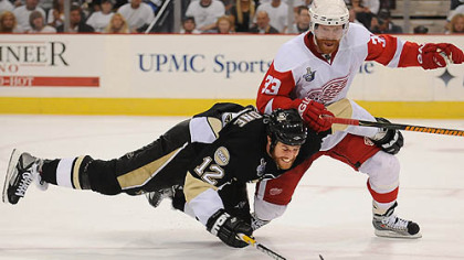 Ryan Malone battles for a loose puck.