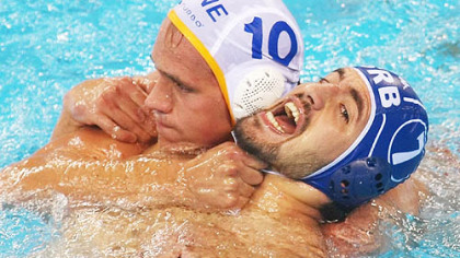 BEIJING -- Montenegro's Boris Zlokovic grabs hold of the ties to the cap of Serbia's Nikola Radjen.