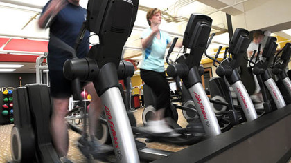 Phil Ashton, 41, a Heinz employee, and Sandy Sabo, 45, who works for Ensr Inc., work out at Gold's Gym, Downtown, during their lunch hour.