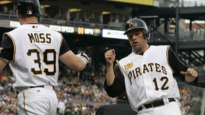 Freddy Sanchez, is greeted by teammate Brandon Moss after scoring in the first inning against the Reds.