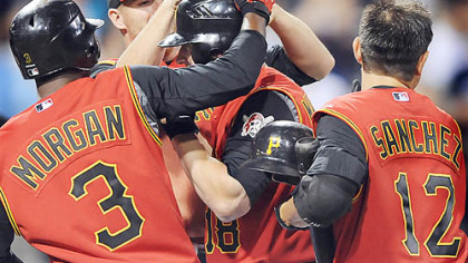 Jason Michaels is greeted at home after hitting the ball that led to winning run in the 12th inning against the Blue Jays last night at PNC Park.