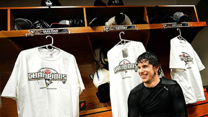 Penguins Sidney Crosby surrounded by Championship t-shirts.