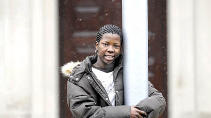 Markel Walker stands beside the flagpole at Schenley High School, where she is a junior.