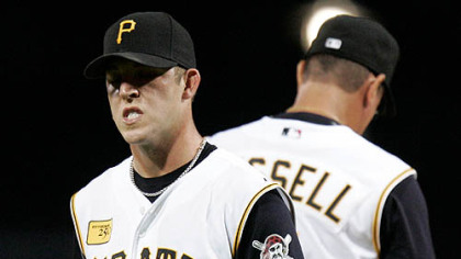 Paul Maholm (28) is pulled by manager John Russell, rear, in the middle of a five-run sixth-inning against the Milwaukee Brewers at PNC Park last night.
